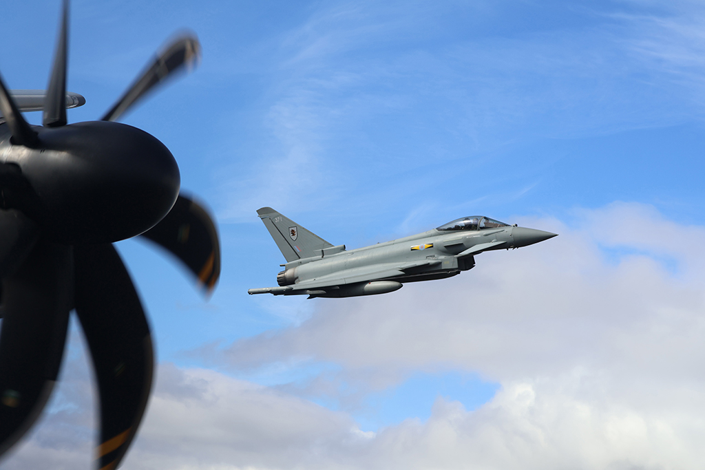 Photo: Image depicts the port outboard propellor of the Atlas, with the typhoon flying alongside just off the port wing 